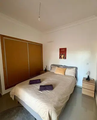 a bedroom with a large bed with two pillows on it at Le cocon d'Asilah Mer et Confort in Oulad Akkou