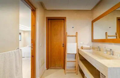 a bathroom with a large mirror and a sink at Villa privée sans vis-à-vis,Padel,Tennis, Five in Oulad Mazoug
