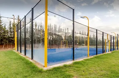 a volleyball court with a net in a field at Villa privée sans vis-à-vis,Padel,Tennis, Five in Oulad Mazoug