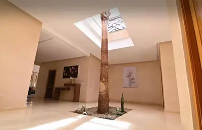 a palm tree in a room with a ceiling at Villa privée sans vis-à-vis,Padel,Tennis, Five in Oulad Mazoug