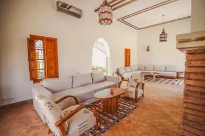 a living room with a couch and chairs and a table at Villa Riad Soles Heated pool Luxury and Beauty in Douar Soukkane