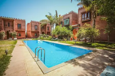 a swimming pool in front of a building at Villa Riad Soles Heated pool Luxury and Beauty in Douar Soukkane
