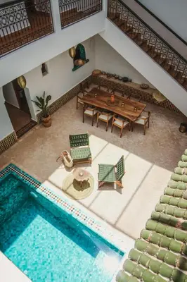 an overhead view of a pool with a table and chairs at Villa Riad Soles Heated pool Luxury and Beauty in Douar Soukkane