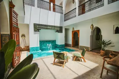 a living room with a pool in the middle at Villa Riad Soles Heated pool Luxury and Beauty in Douar Soukkane