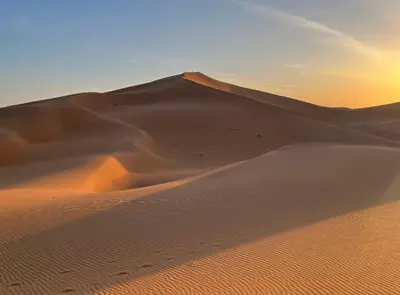 a sand dune in the desert at sunset at Bivouac Desert Du Maroc in Mhamid
