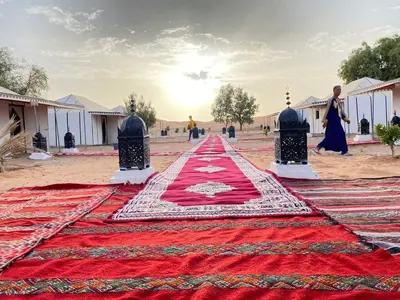 a red carpet on the ground in the desert at kasbah estrella in Merzouga