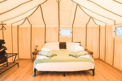 a bedroom with a bed in a tent at kasbah estrella in Merzouga