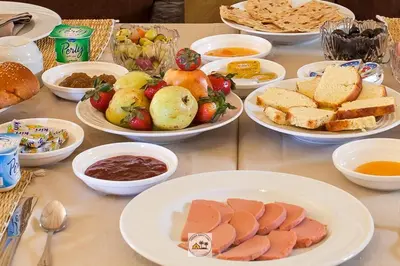 a table with plates of food and bowls of food at kasbah estrella in Merzouga