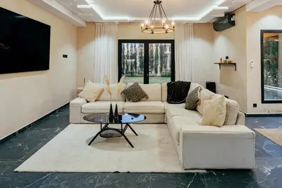 a living room with a couch and a table at Stunning luxury Villa with Mountain Views in Sbiti