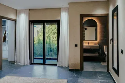 a bathroom with a large glass door and a sink at Stunning luxury Villa with Mountain Views in Sbiti
