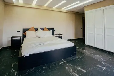 a bedroom with a bed with white sheets and pillows at Stunning luxury Villa with Mountain Views in Sbiti