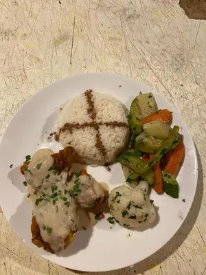a plate of food with rice and vegetables on a table at Magamane luxury camp in Merzouga
