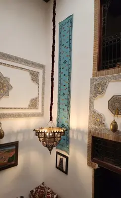 a chandelier hanging from a wall in a room at Dar bab jdid Rcif- step away from historic sites in Fès