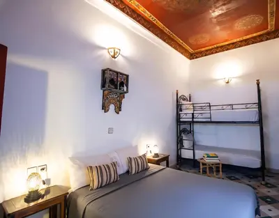 a bedroom with a bed with a gold ceiling at Dar bab jdid Rcif- step away from historic sites in Fès