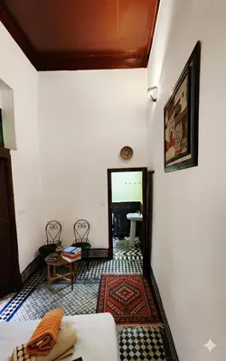 a living room with a couch and a table at Dar bab jdid Rcif- step away from historic sites in Fès