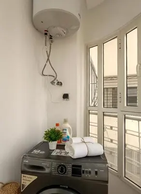 a washing machine in a room with a window at Prestigia Luxury Apartments Fes in Fès