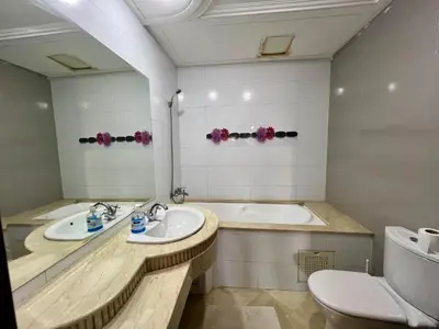 a bathroom with two sinks and a tub and a toilet at Prestigia Luxury Apartments Fes in Fès
