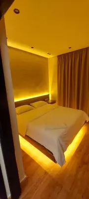 a bedroom with a large white bed with lights at Suite Bahiya unica in Fès