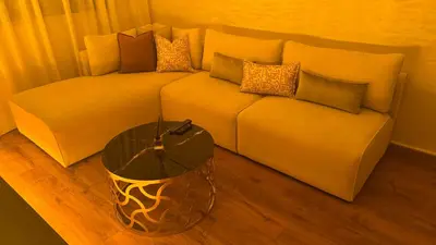 a living room with a couch with a glass table at Suite Bahiya unica in Fès