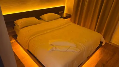a bed with white sheets and pillows in a room at Suite Bahiya unica in Fès
