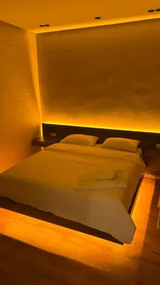 a large white bed in a room with lights at Suite Bahiya unica in Fès
