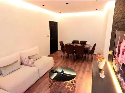 a living room with a white couch and a table at Suite Bahiya unica in Fès