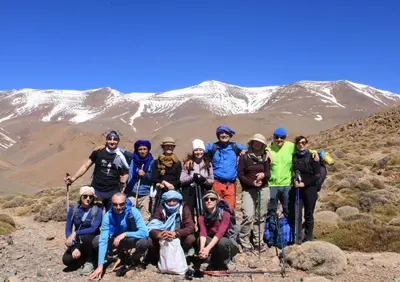 a group of people posing for a picture on a mountain at Auberge le calme restaurante in Bou Tharar