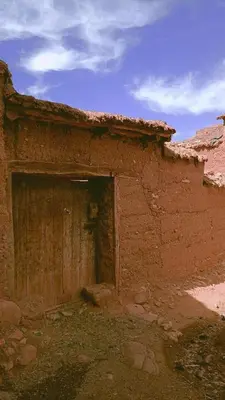 a brick building with a door in the side of it at Dar sonic in Ouarzazate