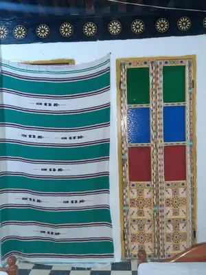 two colorful windows on a wall in a room at chembre Naima mbarki in Fès