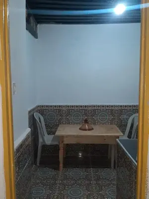 a table and two chairs in a room at chembre Naima mbarki in Fès