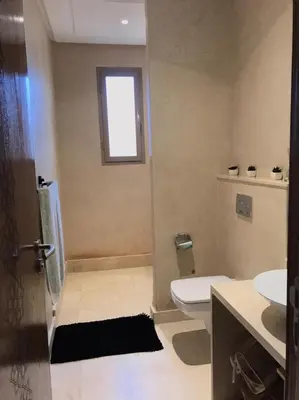 a bathroom with a toilet and a window at Villa à Marrakech-avec piscine privėe in Douar Soukkane
