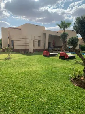 a house with a large lawn in front of it at Villa à Marrakech-avec piscine privėe in Douar Soukkane