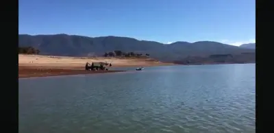 a group of horses standing on the shore of a body of water at slimane in Aït Hallouane