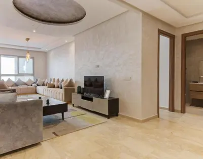 a living room with a couch and a table at slimane in Aït Hallouane