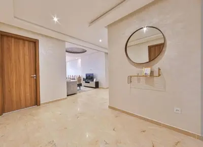 a hallway with a mirror on a wall at slimane in Aït Hallouane