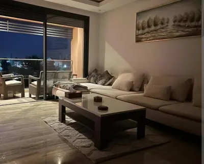 a living room with a couch and a coffee table at slimane in Aït Hallouane