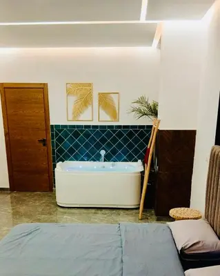 a bathroom with a bath tub in a room at Villa 3chambres Aéroport de Fès Piscine Jacuzzi in Oulad Tayeb