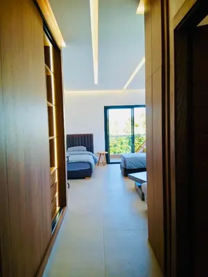 a room with a hallway with two beds and a window at Résidence Fès Garden Piscine privé ou Jacuzzi in Oulad Tayeb
