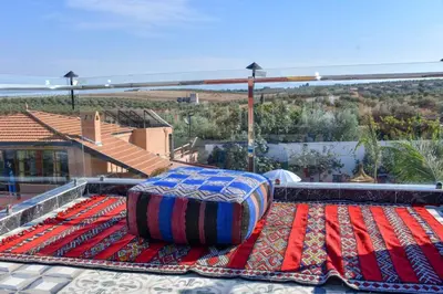 a large mattress sitting on top of a rug on a roof at Tynass Ferme - Fes in Fès