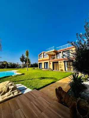 a large house with a yard with a swimming pool at Tynass Ferme - Fes in Fès