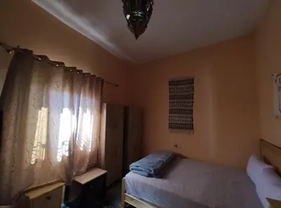 a bedroom with a bed and a window at Asmaa Guesthouse Todra in Tinerhir
