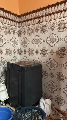 a tiled wall with a tv in a kitchen at dar cherfa lbettaouien in Oulad Akkou