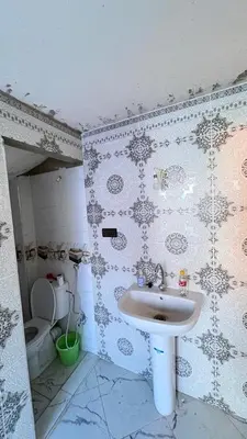 a bathroom with a sink and a toilet at dar cherfa lbettaouien in Oulad Akkou