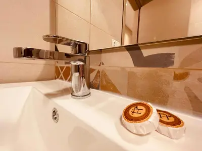 a bathroom sink with a chrome faucet and a mirror at Zyon Family in Oulad Akkou