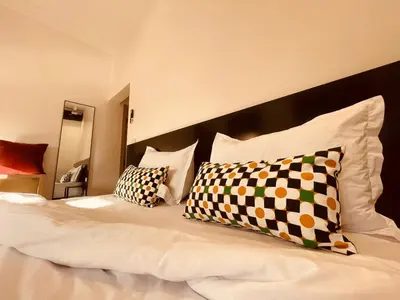a bed with two pillows on top of it at Zyon Family in Oulad Akkou