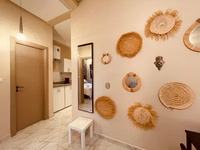 a room with a mirror and some straw hats on the wall at Zyon Family in Oulad Akkou