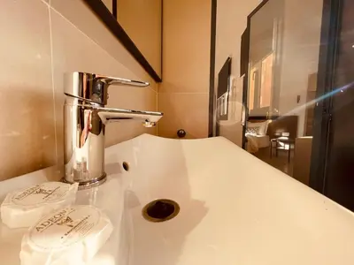 a bathroom with a white counter with a sink at Zyon Family in Oulad Akkou
