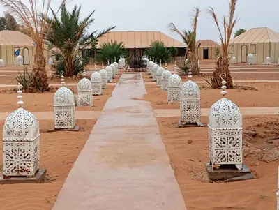 a row of white barriers in the desert at Amandesertcamp in Lac Yasmins