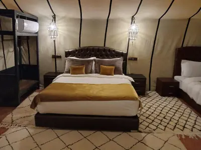 a bedroom with a large bed in a tent at Amandesertcamp in Lac Yasmins