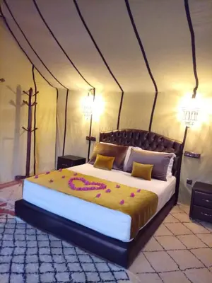 a bedroom with a large bed in a tent at Amandesertcamp in Lac Yasmins